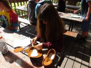 Gigi working on moccasins at the Craft Shack