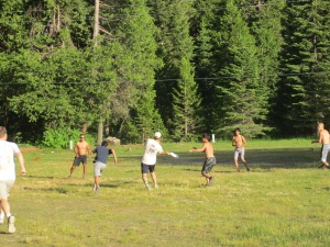 Playing Ultimate in the field next to Camp Gaines