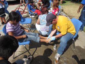 Jason washing a child's feet during Faithful Feet at El Encino Baptist Church