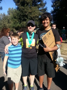 Jason poses with medal after finishing 1:2 marathon with Zach and Markus