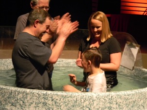 Jason and Stacy baptizing Zach at Clovis Hills